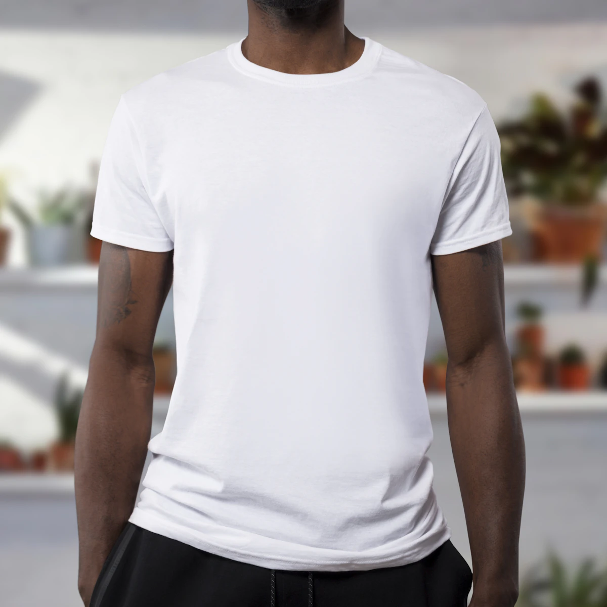 Person wearing a plain white t-shirt